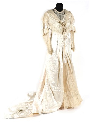 Lot 2128 - Circa 1900 Cream Silk Wedding Dress, comprising a lace shawl mount and modesty panel, short sleeves