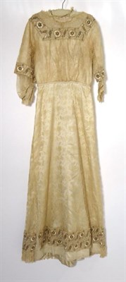 Lot 2135 - An Edwardian Wedding Dress, in cream silk with floral lace mount, short sleeves with silk...