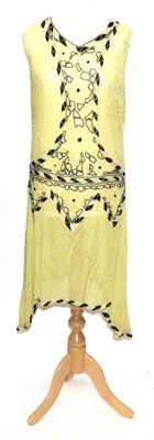 Lot 2139 - Circa 1920s French Sleeveless Flapper Dress, worked on yellow muslin, with black and clear...