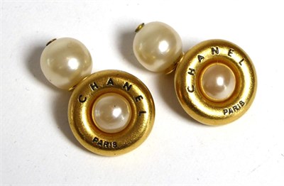 Lot 2242 - A Pair of Chanel Cufflinks, simulated pearls within gilt metal borders signed 'CHANEL Paris', chain