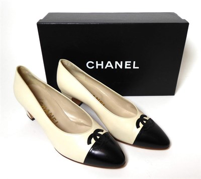 Lot 2269 - Pair of Chanel Cream Leather Block Heel Court Shoes, with black interlocking 'CC' motif overlapping