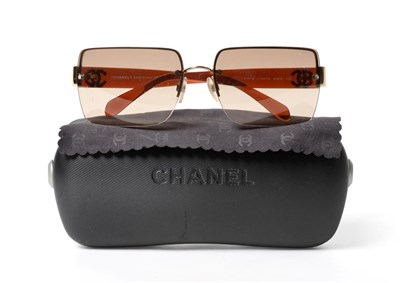 Lot 2271 - Chanel Sunglasses, sepia lenses and amber coloured arms mounted with gold-tone interlocking...