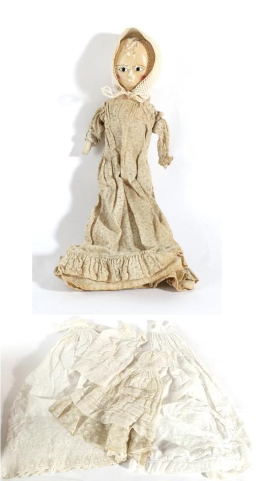 Lot 2002 - A Late 18th/Early 19th Century Wooden Doll, with large almond shaped eyes, stitched eyebrows...