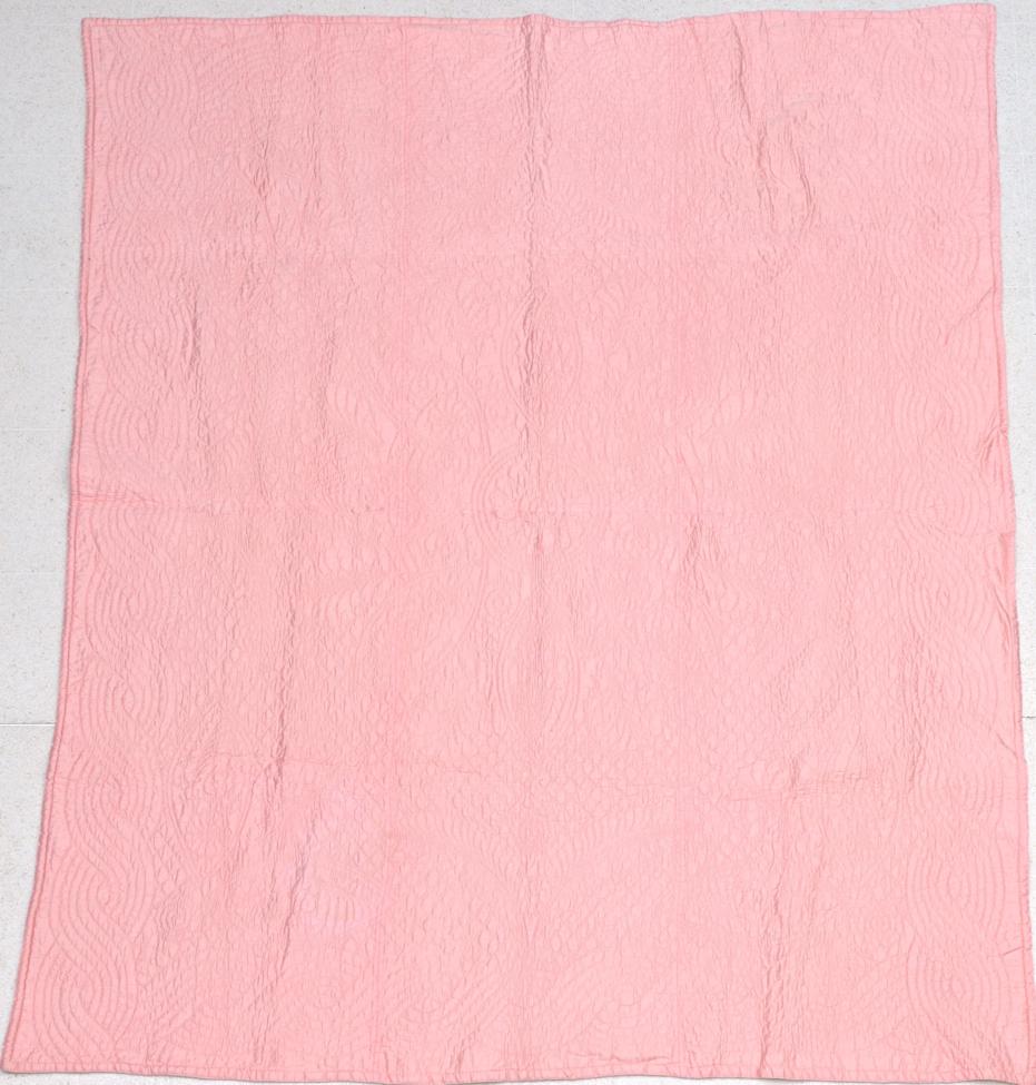Lot 2065 - Early 20th Century Salmon Pink Quilt, reversible with yellow, quilted with a central rose...