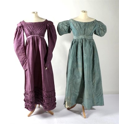 Lot 2114 - An Early 19th Century Purple Silk Dress, with empire style bust, gathered with three trims,...