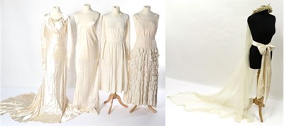 Lot 2129 - Circa 1930s Cream Wedding Dress, with slash neck mounted with wax flower heads, long sleeves...