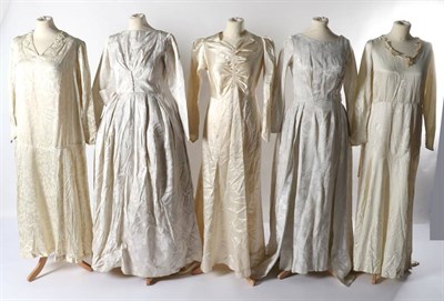 Lot 2134 - Circa 1920s and Later Wedding Dresses, comprising a cream floral printed silk drop waist dress,...