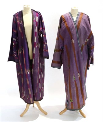 Lot 2199 - An Early 20th Century Uzbekistan Chapan, in purple figured silk woven with sprigs of flowers...