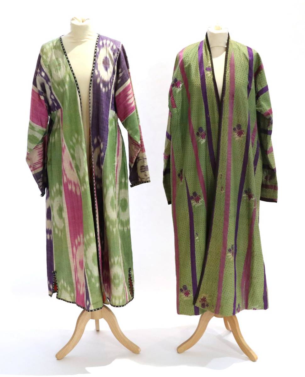 Lot 2201 - An Early 20th Century Uzbekistan Chapan, in green figured silk woven with sprigs of flowers and...