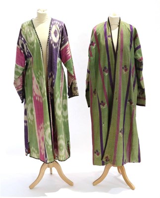 Lot 2201 - An Early 20th Century Uzbekistan Chapan, in green figured silk woven with sprigs of flowers and...