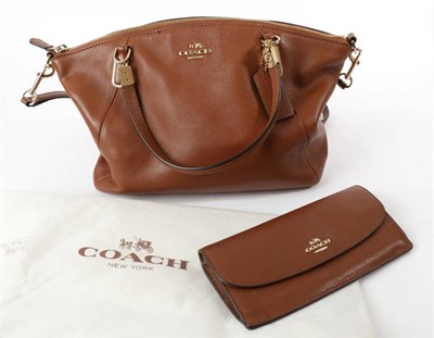 Lot 2267 - Coach Small 'Kelsey' Brown Pebble Leather Hand / Cross Body Bag, with twin carry handles and...