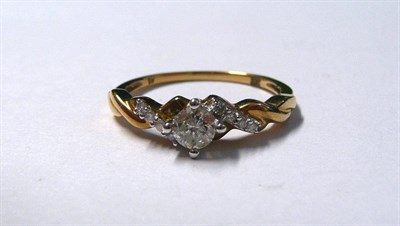 Lot 6 - A 9 Carat Gold Diamond Ring, a central round brilliant cut diamond with smaller diamond details...