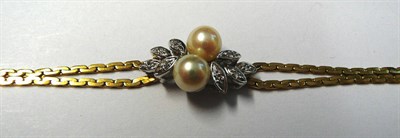 Lot 8 - An 18 Carat Gold Cultured Pearl and Diamond Bracelet, two cultured pearls on a twist centre...