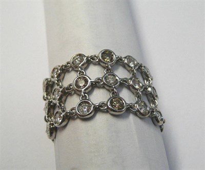 Lot 9 - A Diamond Ring, chain linked spectacle set round brilliant cut diamonds on a plain polished...