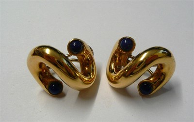 Lot 11 - A Pair of Lapis Lazuli Earrings, plain yellow tubes of swirl form with a cabochon lapis lazuli...