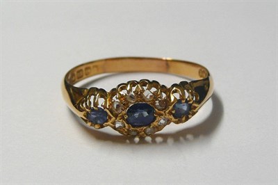 Lot 12 - An 18 Carat Gold Sapphire and Diamond Ring, a central sapphire and diamond cluster, with a sapphire