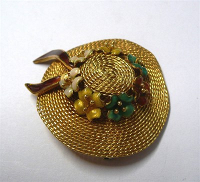 Lot 22 - An Enamelled Hat Brooch, the rope twisted hat with enamelled flowers and a ribbon, measures...