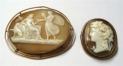 Lot 27 - An Oval Shell Cameo Brooch, depicting a classical scene, in a lined frame, measures 6.4cm by 5.4cm