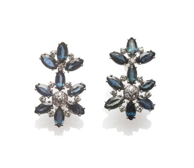 Lot 30 - A Pair of 18 Carat White Gold Sapphire and Diamond Drop Earrings, of floral cluster form, in...