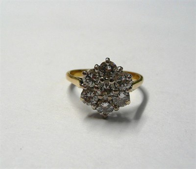 Lot 36 - A Diamond Cluster Ring, seven round brilliant cut diamonds in white claw settings, on a yellow...