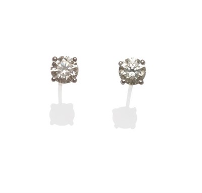 Lot 41 - A Pair of Diamond Solitaire Stud Earrings, each round brilliant cut diamond in a white four...