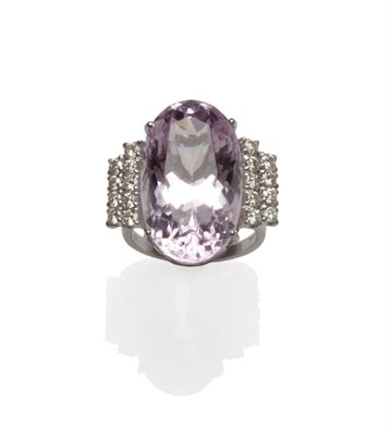 Lot 43 - An 18 Carat White Gold Kunzite and Diamond Ring, the central oval cut kunzite flanked by two...