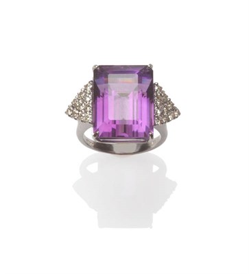 Lot 45 - An 18 Carat White Gold Amethyst and Diamond Ring, the step cut amethyst flanked by a triangular...