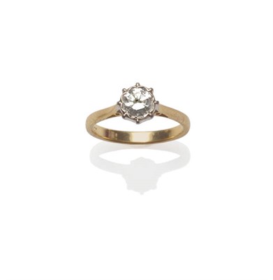 Lot 47 - A Diamond Solitaire Ring, a round brilliant cut diamond in a white setting to a yellow tapered...