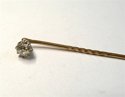 Lot 50 - A Diamond Set Stick Pin, an old cut diamond in a white claw setting to a yellow pin with midway...