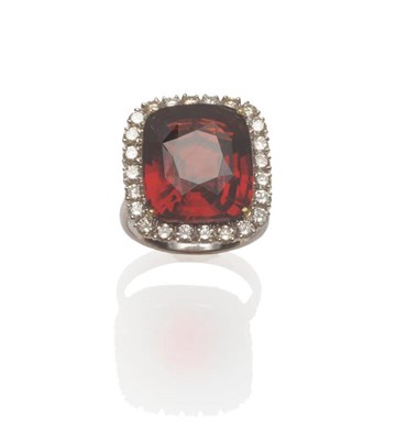 Lot 60 - An 18 Carat White Gold Garnet and Diamond Cluster Ring, a mixed cushion cut garnet within a...