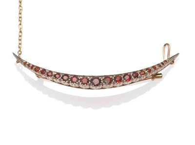 Lot 66 - A Garnet Crescent Brooch, round brilliant stones graduate along the length, in white claw settings