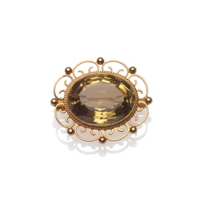 Lot 67 - A 9 Carat Gold Smokey Quartz Brooch, the oval cut stone within a rope twist collet setting, to...