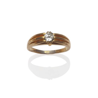 Lot 72 - A Diamond Solitaire Ring, the round brilliant cut diamond in a yellow claw setting to tramline...