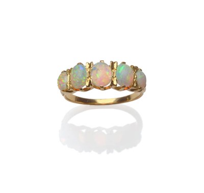 Lot 78 - An Opal Cabochon Five Stone Ring, five oval cabochon opals in yellow claw settings to carved...