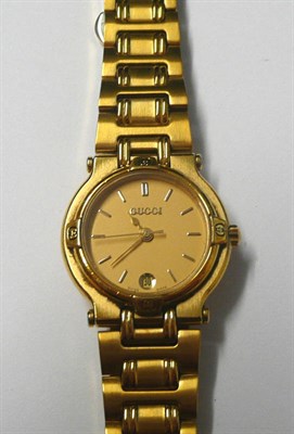 Lot 83 - A Lady's Gilt Calendar Centre Seconds Quartz Wristwatch, signed Gucci, circa 2000, quartz movement