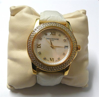 Lot 86 - A Gilt and Diamond Set Calendar Centre Seconds Quartz Wristwatch, signed Saint Honore, Paris, circa