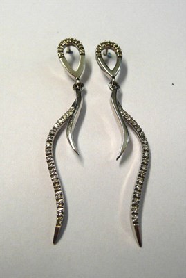 Lot 91 - A Pair of 18 Carat White Gold Diamond Drop Earrings, an open teardrop shape suspends two...