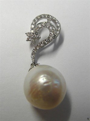 Lot 114 - A Diamond and Pearl Pendant, a cluster of round brilliant cut diamonds to a swirl, in white...