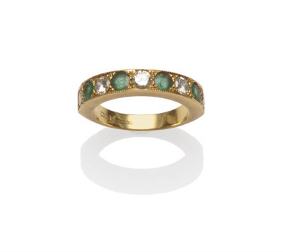 Lot 123 - An 18 Carat Gold Emerald and Diamond Half Eternity Ring, the round brilliant cut stones...