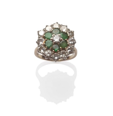 Lot 130 - A Three Row Emerald and Diamond Cluster Ring, a round brilliant cut diamond to the centre, bordered