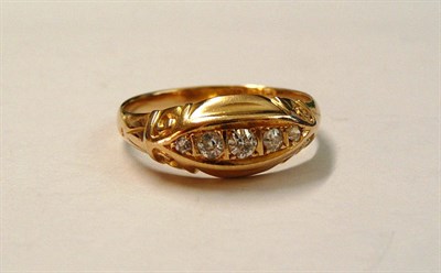 Lot 135 - An 18 Carat Gold Diamond Five Stone Ring, the graduated old cut diamonds in a carved setting to...