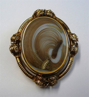 Lot 137 - A Victorian Locket Brooch, the swivel locket centre panel containing hair and small pearls,...