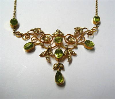 Lot 139 - An Early 20th Century Peridot and Seed Pearl Necklace, a central panel of scrolls and floral...