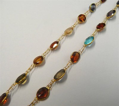 Lot 140 - A Multi Gem Necklace, the graduated oval cut stones include citrine, amethyst, topaz and...