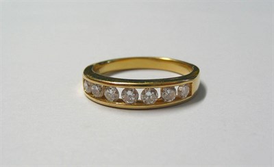 Lot 145 - A Diamond Half Eternity Ring, seven round brilliant cut diamonds in a yellow channel setting,...