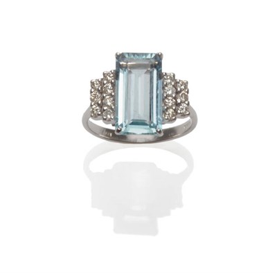 Lot 156 - An 18 Carat White Gold Aquamarine and Diamond Ring, the step cut aquamarine with two rows of...