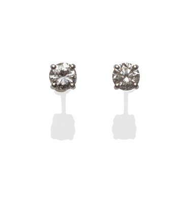 Lot 157 - A Pair of 18 Carat White Gold Diamond Solitaire Stud Earrings, each round brilliant cut diamond...