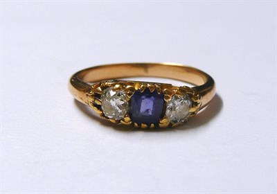 Lot 175 - A Sapphire and Diamond Three Stone Ring, the cushion cut sapphire flanked by an old cut diamond...