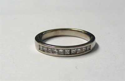 Lot 177 - A Platinum Diamond Half Eternity Ring, princess cut diamonds channel set to a plain polished shank