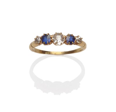 Lot 179 - A Diamond and Sapphire Five Stone Ring, the graduated old cut stones alternate in yellow claw...